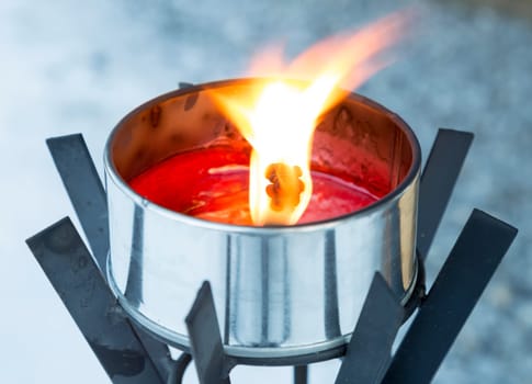 Light Burning in Metal Can close up.