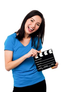 Cheerful woman posing with clapper board