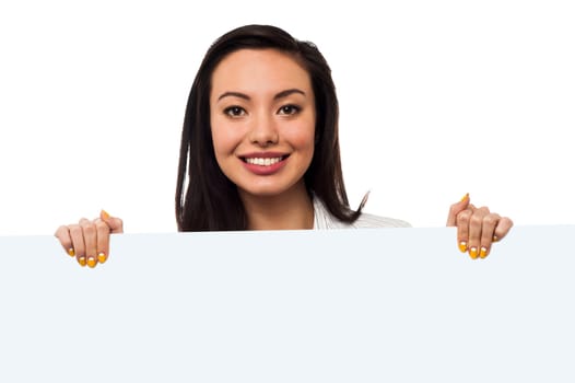Young woman holding blank whiteboard