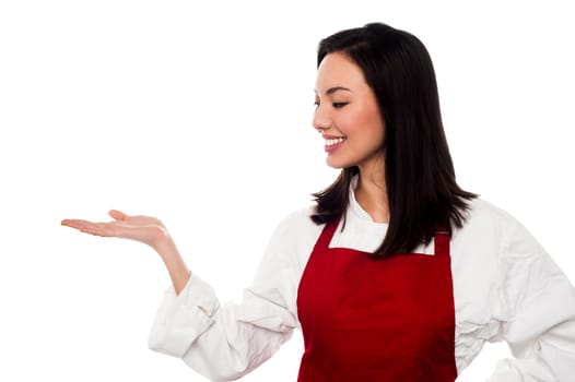 Young female chef presenting something