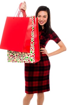 Pretty woman showing shopping bags