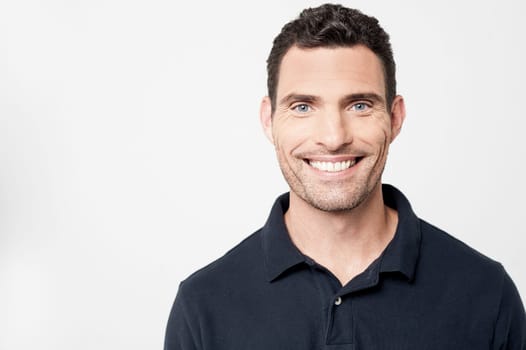 Smiling middle aged man posing over grey background