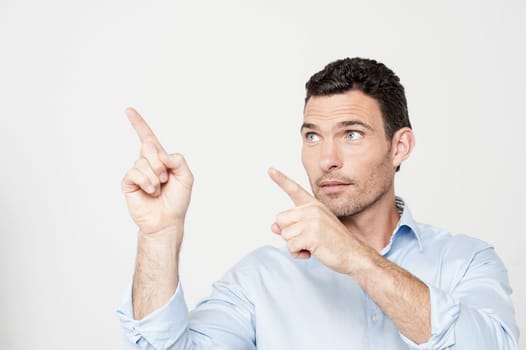Attractive middle-aged man pointing to the side