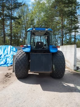 back of one big blue tractor with big wheel