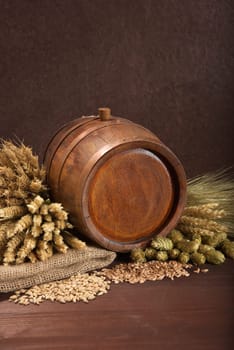 Old barrel with wheat,barley,hops and malt