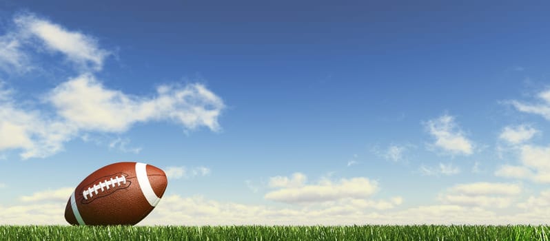 American football ball, on the grass, with fluffy couds sky in the background. Side view, from ground level, panoramic format.