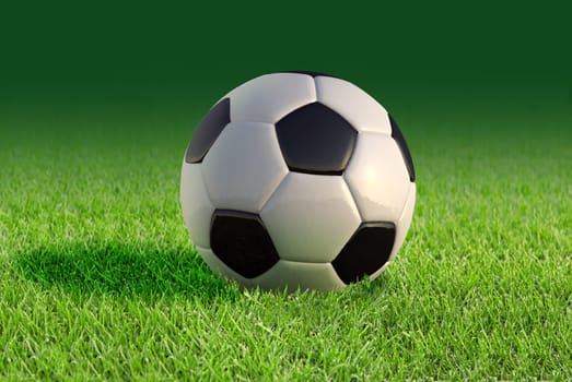 Soccer ball close up on grass lawn, with fading green background.