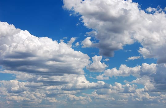 Blue sky with many cumulus white clouds.