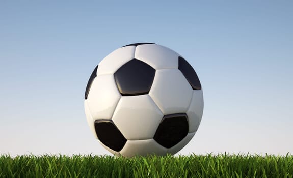 Soccer ball close up on grass lawn. Viewed from ground level. In sunny day light..With blue sky and no clouds as background. Clipping path included.
