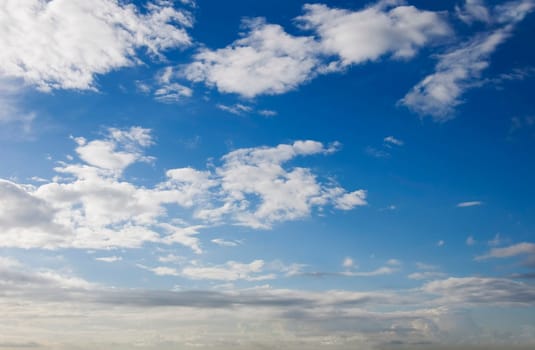 Blue sky with some cumulus white clouds.