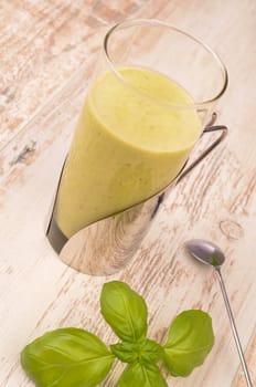 Green smoothie on a wooden table