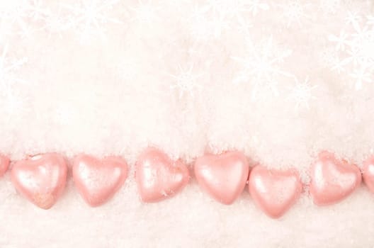 Heart shapes in snow, christmas background with space for text or image