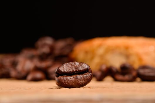 Close up of an espresso bean in front of Italian short bread