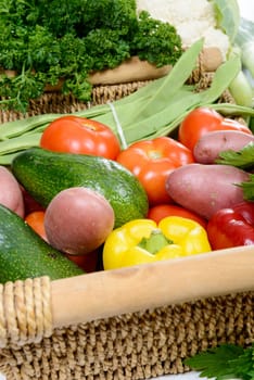 a basket of seasonal vegetables on  wooden table