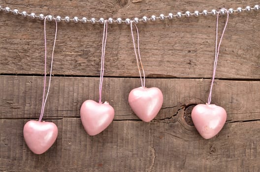 Vintage heart shapes on a rustic wooden background, love concept