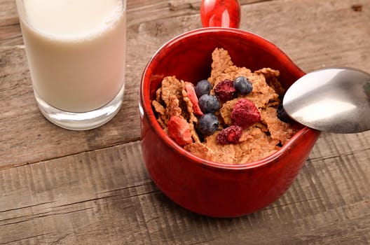 Muesli with organic milk on a rustic wooden background