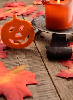 Felt pumpkin with leaves on a rustic wooden table
