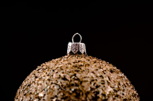 golden Christmas bauble on a dark background