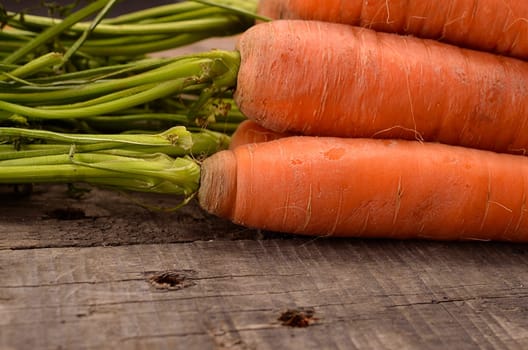 Close up of fresh raw organic carrots on old wood