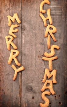 Sweet Merry Christmas cookies on a rustic wooden table