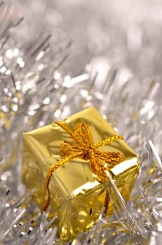 Golden Christmas present with silver decoration