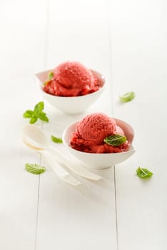 Fresh fruit sorbet ice cream in a white bowl.