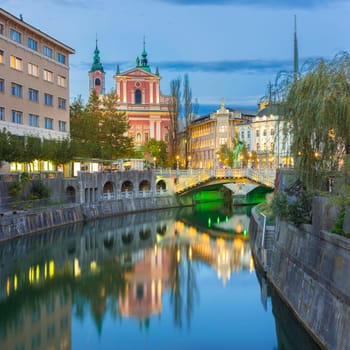 Romantic Ljubljana city center. River Ljubljanica, Triple Bridge - Tromostovje, Preseren square and Franciscan Church of the Annunciation. Ljubljana Slovenia Europe.