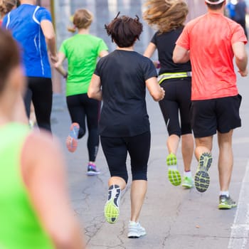 Group of active people running in the city. Healthy lifestyle. Weight Loss. Urban marathon run.