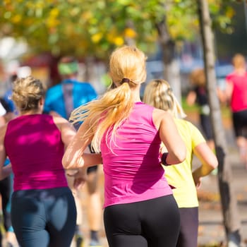 Group of active people running in the city. Healthy lifestyle. Weight Loss. Urban marathon run.