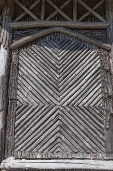 Side wall of a building decorated with roundwood