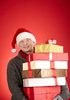 Portrait of generous Santa man with pile of giftboxes
