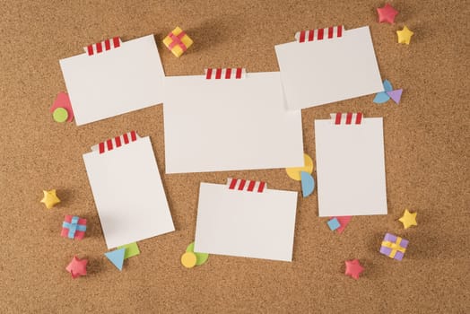 Set of blank paper template notes taped on cork notice board with colorful handmade elements. Includes clipping path mock up for design your own portfolio, school, office or stationery...
