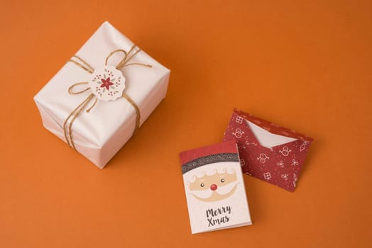 Merry Christmas top view scene composition with rustic vintage gift box, label and holiday greeting card.