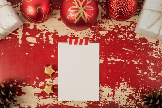 Holiday greeting card top view concept mockup with Christmas decoration and vintage elements on hipster grunge wood background. Includes clipping path.