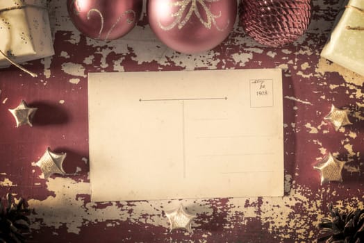 Merry christmas retro top view empty greeting card back on grunge wood texture background with holiday elements and vintage filter effect. Includes clipping path for postcard.