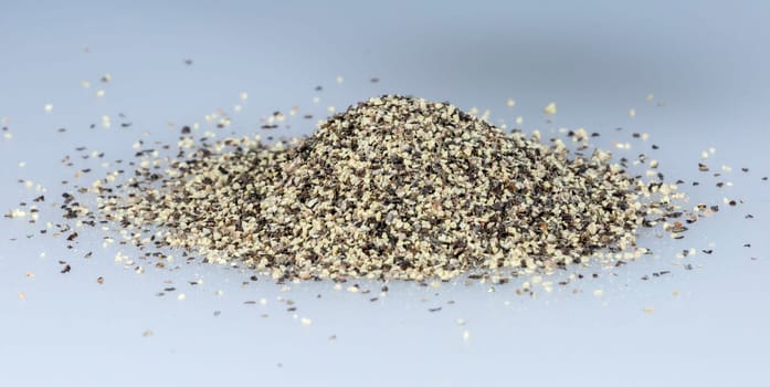 Black Pepper Grains in a pile close up.