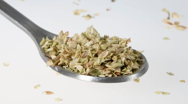 Dried Oregano on Tablespoon close up.