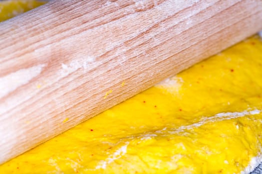 Saffron Bun Dough with Roller close up macro image.