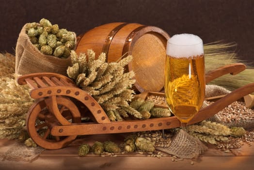 Beer glass with barrel,wheelbarrow,wheat,barley,hops and malt