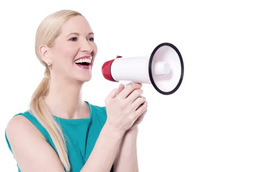 Cheerful woman making announcement with loudhailer