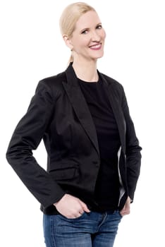 Stylish woman posing with hands in her pockets