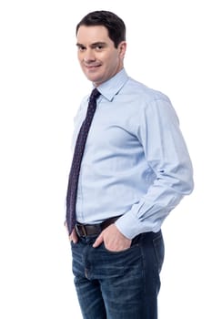 Business executive standing with his hands in pockets