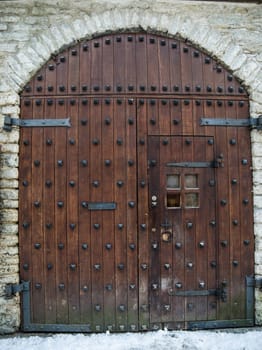 Ancient wooden gate with forged elements, close up