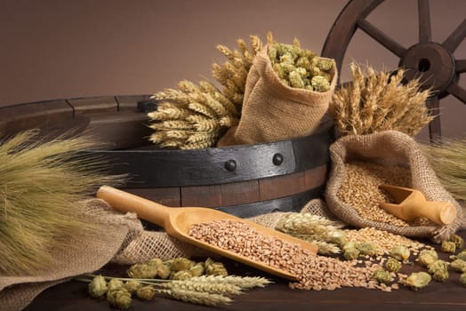 Beer barrel with wheat,barley,hops and malt