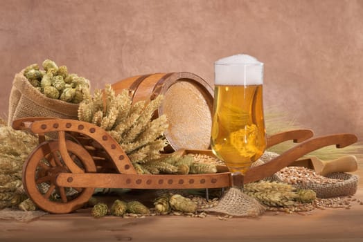 Beer glass with barrel,wheelbarrow,wheat,barley,hops and malt