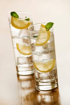 Two glasses of Fresh Mineral water with ice and lemon.
