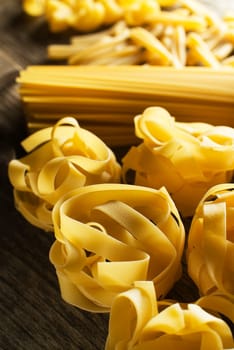 Mixed dry Pasta collection background close up.