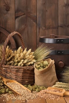 Old beer barrel with wheat,barley,hops and malt