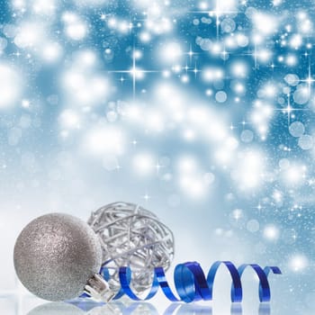 Christmas balls and ornaments in front of glittering background