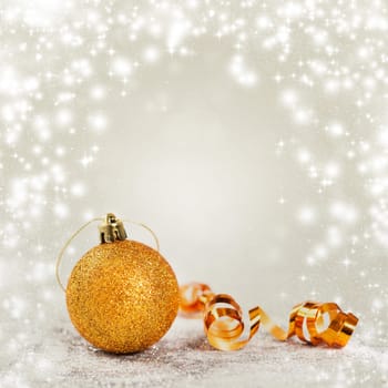 Christmas balls and ornaments in front of glittering background